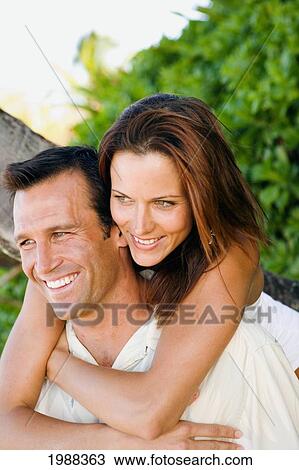 Hawaii, Oahu, North Shore, Happy Embracing On Beach In Warm Afternoon Light, Green Vegetation Behind. View Large Photo Image Stock Image - Hawaii, Oahu, North Shore, Happy Embracing On Beach In Warm Afternoon Light, Green Vegetation Behind.. Fotosearch
