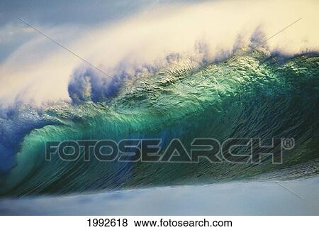 Stock Photo - Hawaii, Oahu, North Shore; Large Green Wave About To Curl With Mist Blowing Off Tip. Fotosearch