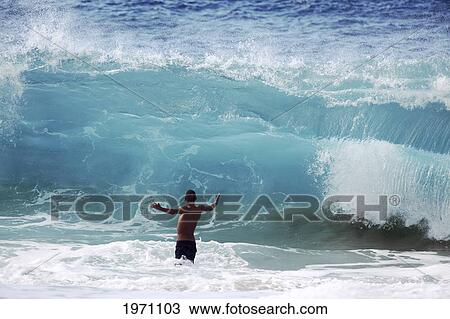 Stock Image - Hawaii, Oahu, North Shore, Man Is About To Be Crushed By Giant Wave. (Editorial Use Only).. Fotosearch