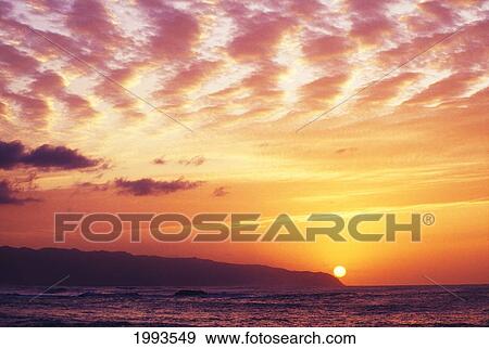 Stock Photo - Hawaii, Oahu, North Shore, Overview Of Waimea Bay At Sunset, Dramatic Clouds.. Fotosearch