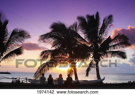 Stock Image - Hawaii, Oahu, North Shore, People Watching A Beautiful Sunset.. Fotosearch