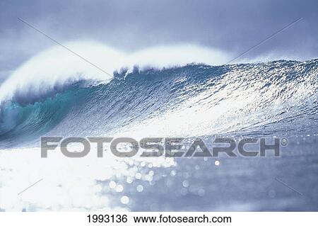 Stock Photograph - Hawaii, Oahu, North Shore, Pipeline, Big Wave Breaking At Sunset, Shimmery Water.. Fotosearch