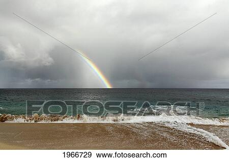 Stock Photo - Hawaii, Oahu, North Shore, Rain And Rainbows Above Ocean.. Fotosearch