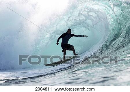 Stock Image - Hawaii, Oahu, North Shore, Silhouette Of A Surfer Inside The Barrel Of A Large Wave. Editorial Use Only.. Fotosearch