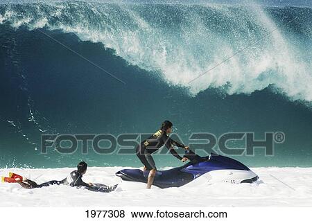Stock Photo - Hawaii, Oahu, North Shore, Surfer Being Towed By Pipeline Lifeguard.. Fotosearch