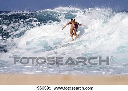 Stock Photography - Hawaii, Oahu, North Shore, Surfer Girl Catching A Wave.. Fotosearch