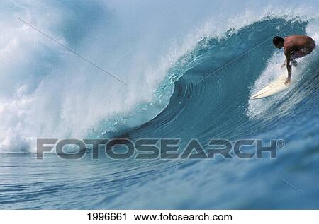 Stock Image - Hawaii, Oahu, North Shore, Surfer Riding Tight Curling Wave, Big Crest. Fotosearch