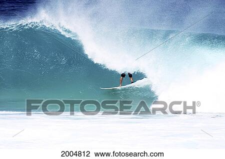 Stock Image - Hawaii, Oahu, North Shore, Surfer Inside The Barrel Of A Large Wave, Only Legs Showing. Editorial Use Only.. Fotosearch
