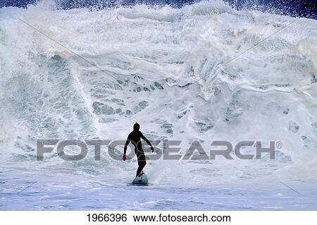 Stock Photograph - Hawaii, Oahu, North Shore, Surfer Riding In Front Of A Giant Wave.. Fotosearch