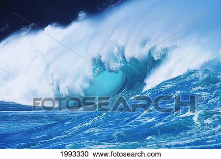 Stock Image - Hawaii, Oahu, North Shore; Turquoise Wave Curling Crashing With Mist Blowing Off Tip. Fotosearch
