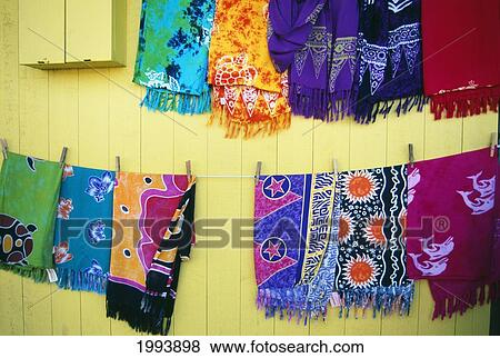 Stock Photo - Hawaii, Oahu, North Shore, View Of Colorful Pareos Hanging On Line For Sale. Fotosearch