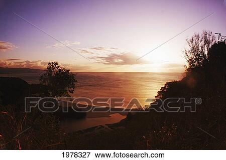 Hawaii, Oahu, North Shore, Waimea Bay, Beautiful Sunset Over The Ocean. View Large Photo Image Stock Photo - Hawaii, Oahu, North Shore, Waimea Bay, Beautiful Sunset Over The Ocean.. Fotosearch