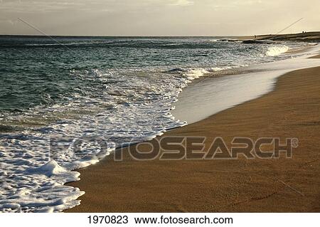 Stock Image - Hawaii, Oahu, North Shore, Waves Rolling Onto An Empty Beach. Fotosearch
