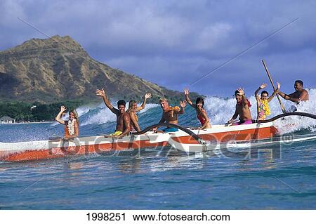 Stock Image - Hawaii, Oahu, Outrigger Fun Enjoying Waves Of Waikiki Diamond Head Background. Fotosearch