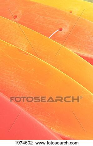 Stock Image - Hawaii, Oahu, Pattern Shot Of Orange Yellow Kayaks Stacked On Each Other.. Fotosearch