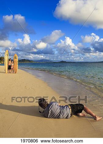 Hawaii, Oahu, Photographer Shooting A Portrait Session On The Beach View Large Photo Image Stock Photograph - Hawaii, Oahu, Photographer Shooting A Portrait Session On The Beach. Fotosearch