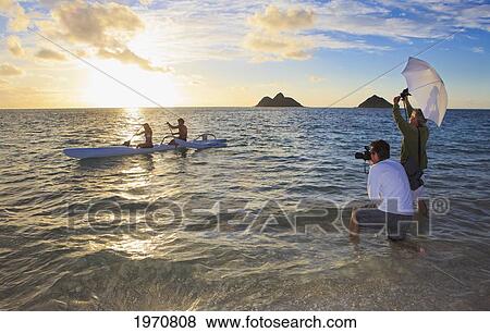 Stock Photo - Hawaii, Oahu, Photoshoot In The Ocean At Sunset. Fotosearch