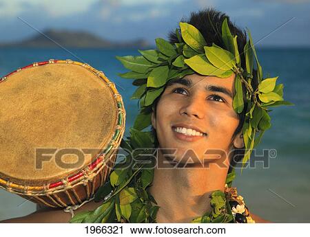 Stock Image - Hawaii, Oahu, Polynesian Man With Drum Along Windward Coast, Sunrise Light.. Fotosearch