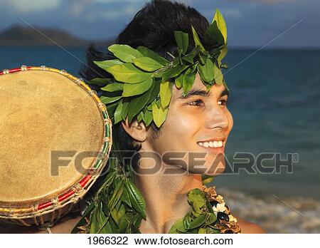 Stock Image - Hawaii, Oahu, Polynesian Man With Drum Along Windward Coast, Sunrise Light.. Fotosearch