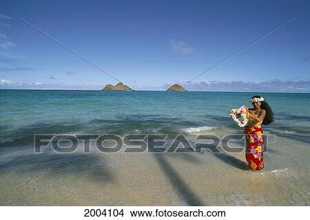 Picture - Hawaii, Oahu, Polynesian Woman On Shoreline Offering Leis, Palm Shadow Mokulua Islands Background Blue Sky. Fotosearch