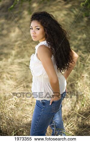 Stock Photography - Hawaii, Oahu, Portrait A Young Woman In A White Top And Jeans.. Fotosearch