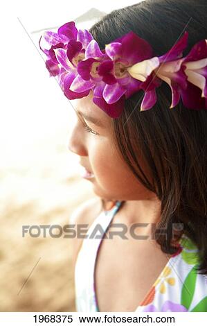 Stock Photography - Hawaii, Oahu, Profile Shot Of A Young Girl Wearing An Orchid Haku, Soft Focus.. Fotosearch