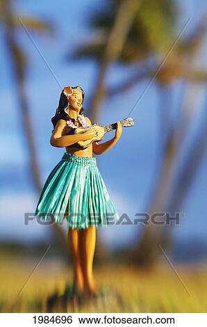 Hawaii, Oahu, Punaluu, Hula Doll On The Grass Beneath Palm Trees. View Large Photo Image Stock Photograph - Hawaii, Oahu, Punaluu, Hula Doll On The Grass Beneath Palm Trees.. Fotosearch