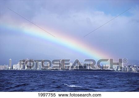 Stock Photography - Hawaii, Oahu, Rainbow Over Waikiki View From Ocean Looking To Skyline. Fotosearch