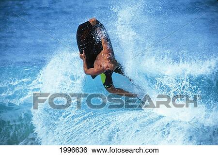 Stock Photograph - Hawaii, Oahu, Sandy Beach, Body Boarder Mike Stewart In Midair Off The Lip. Fotosearch