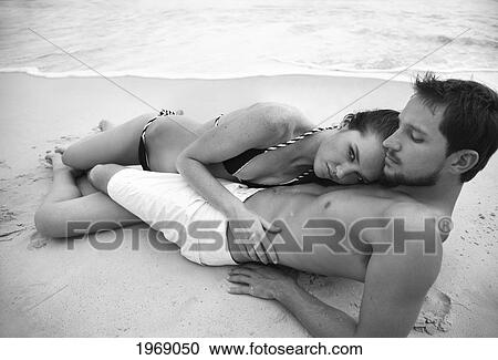 Hawaii, Oahu, Sexy Attractive Young Couple Holding And Laying Together On The Beach, Black & White Version View Large Photo Image Stock Image - Hawaii, Oahu, Sexy Attractive Young Couple Holding And Laying Together On The Beach, Black & White Version. Fotosearch