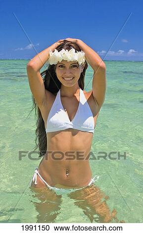 Stock Image - Hawaii, Oahu, Sexy Polynesian Woman Standing In The Ocean In White Bathing Suit. Fotosearch