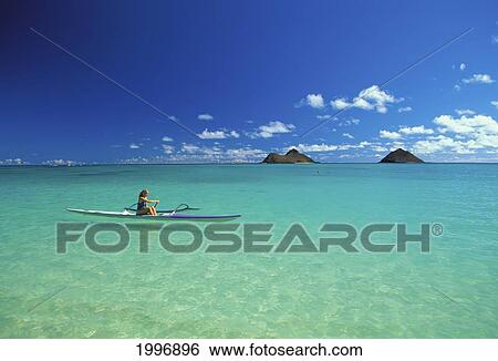 Hawaii, Oahu, Side View Of Woman In Distance Paddling Single Outrigger, Turquoise Water, Mokulua Islands In Background View Large Photo Image Stock Photograph - Hawaii, Oahu, Side View Of Woman In Distance Paddling Single Outrigger, Turquoise Water, Mokulua Islands In Background. Fotosearch