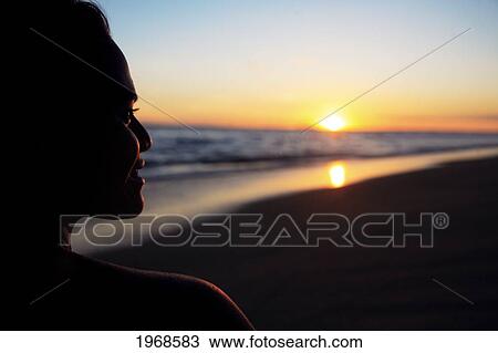 Stock Image - Hawaii, Oahu, Silhouette Of A Female At Sunset. Fotosearch
