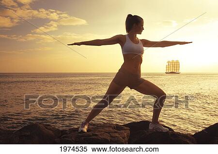 Hawaii, Oahu, Silhouette Of Beautiful Girl Standing On The Rocky Coastline As The Sun Sets With Boat In Background. View Large Photo Image Stock Photography - Hawaii, Oahu, Silhouette Of Beautiful Girl Standing On The Rocky Coastline As The Sun Sets With Boat In Background.. Fotosearch