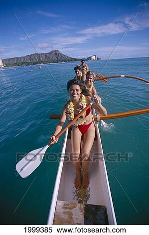 Stock Photography - Hawaii, Oahu, Smiling People With Lei In Outrigger Canoe, Diamond Head Background, Blue Skies. Fotosearch