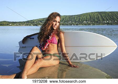 Hawaii, Oahu, Surfer Girl Sitting In Very Shallow Water. Editorial Use Only. View Large Photo Image Stock Photo - Hawaii, Oahu, Surfer Girl Sitting In Very Shallow Water. Editorial Use Only.. Fotosearch