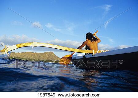 Hawaii, Oahu, Topless Woman Paddling Outrigger Canoe, Diamond Head In Distance, View From Behind. No Model Release View Large Photo Image Stock Photo - Hawaii, Oahu, Topless Woman Paddling Outrigger Canoe, Diamond Head In Distance, View From Behind. No Model Release. Fotosearch