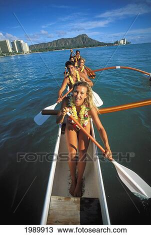 Stock Image - Hawaii, Oahu, Tourists And Local People With Lei In Outrigger Canoe, Diamond Head Background. Fotosearch