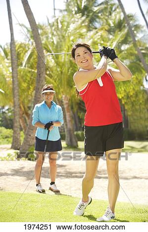 Hawaii, Oahu, Two Woman Enjoying A Day Of Golf. View Large Photo Image Stock Image - Hawaii, Oahu, Two Woman Enjoying A Day Of Golf.. Fotosearch