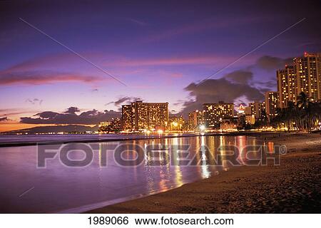 Hawaii, Oahu, Waikiki Beach, Reflection Of City Lights On The Ocean At Twilight. View Large Photo Image Stock Photograph - Hawaii, Oahu, Waikiki Beach, Reflection Of City Lights On The Ocean At Twilight.. Fotosearch