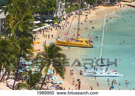 Stock Image - Hawaii, Oahu, Waikiki Beach View Of Sailboats And Tourists From Above [For Use Up To 13X20 Only]. Fotosearch