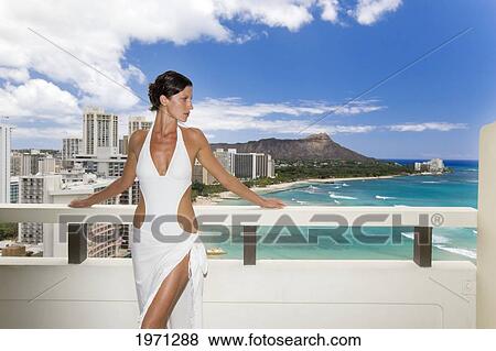 Stock Photo - Hawaii, Oahu, Waikiki, Beautiful Woman On Hotel Balcony Overlooking Waikiki Beach And Diamond Head.. Fotosearch
