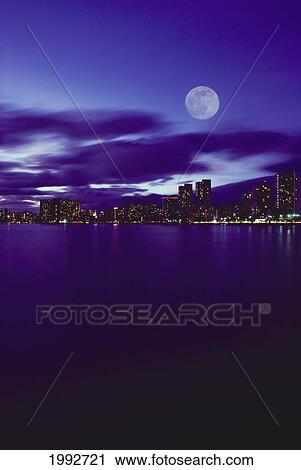 Hawaii, Oahu, Waikiki City Lights With Large Full Moon, Pale Purple Sky With Reflections On Water. View Large Photo Image Stock Image - Hawaii, Oahu, Waikiki City Lights With Large Full Moon, Pale Purple Sky With Reflections On Water.. Fotosearch