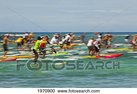 Stock Image - Hawaii, Oahu, Waikiki, Competitors Of 'battle Of The Paddle, ' Blurred Image. (Editorial Use Only). Fotosearch