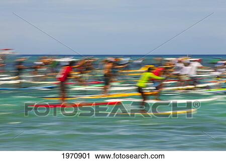 Stock Image - Hawaii, Oahu, Waikiki, Competitors Of 'battle Of The Paddle, ' Blurred Image. (Editorial Use Only). Fotosearch