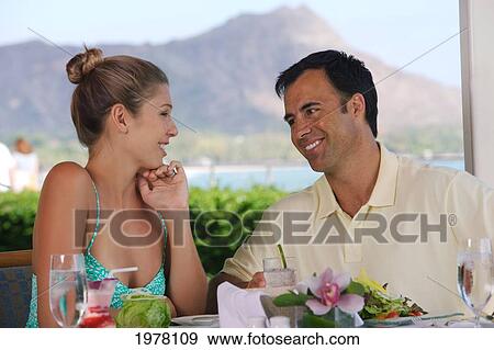 Hawaii, Oahu, Waikiki, Couple At A Restaurant, Diamond Head Background. View Large Photo Image Stock Photo - Hawaii, Oahu, Waikiki, Couple At A Restaurant, Diamond Head Background.. Fotosearch
