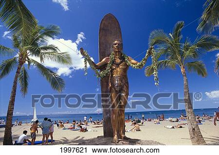 Stock Image - Hawaii, Oahu, Waikiki, Front View Duke Kahanamoku Statue, Beach, Blue Sky And Palms A43E. Fotosearch