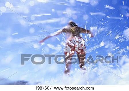 Stock Photo - Hawaii, Oahu, Waikiki, Girl Riding Wave Amid Ocean Spray And Splashes. Fotosearch