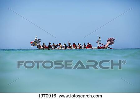 Stock Photograph - Hawaii, Oahu, Waikiki, Group Of People Row A Dragon Boat In The Open Ocean. (Editorial Use Only). Fotosearch