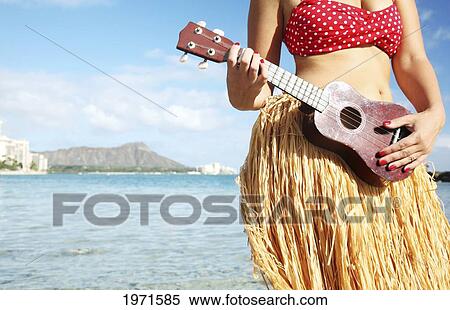 Hawaii, Oahu, Waikiki, Hula Dancer Playing Ukulele Along Beach - Close-Up Of Midriff, Diamond Head In The Distance. View Large Photo Image Stock Photography - Hawaii, Oahu, Waikiki, Hula Dancer Playing Ukulele Along Beach - Close-Up Of Midriff, Diamond Head In The Distance.. Fotosearch